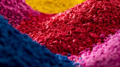 A vibrant pile of colorful powder, showcasing a spectrum of hues in a visually striking arrangement.